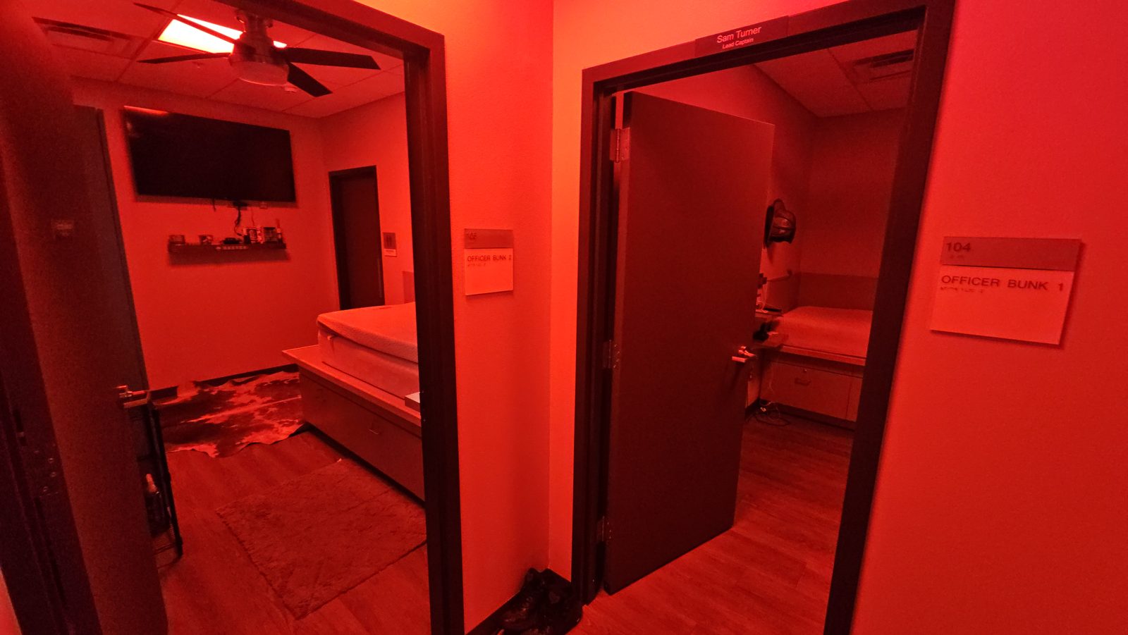 Station 8 bunk room during a live alert, lit entirely in red